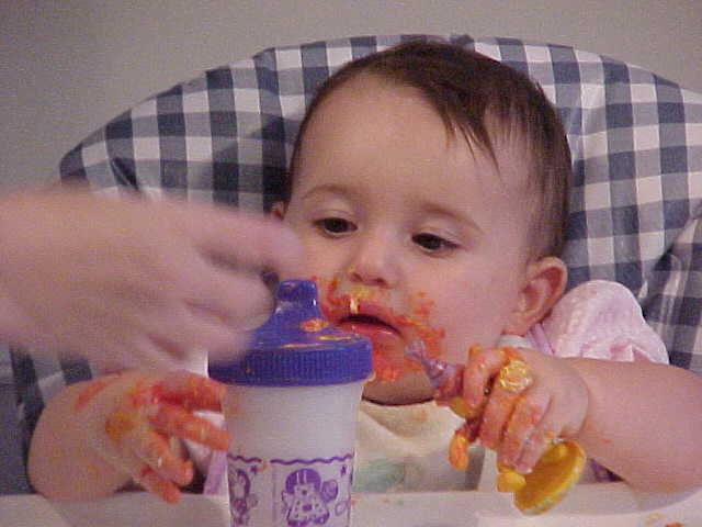 Jocelyn with her 1st birthday cake all over her face