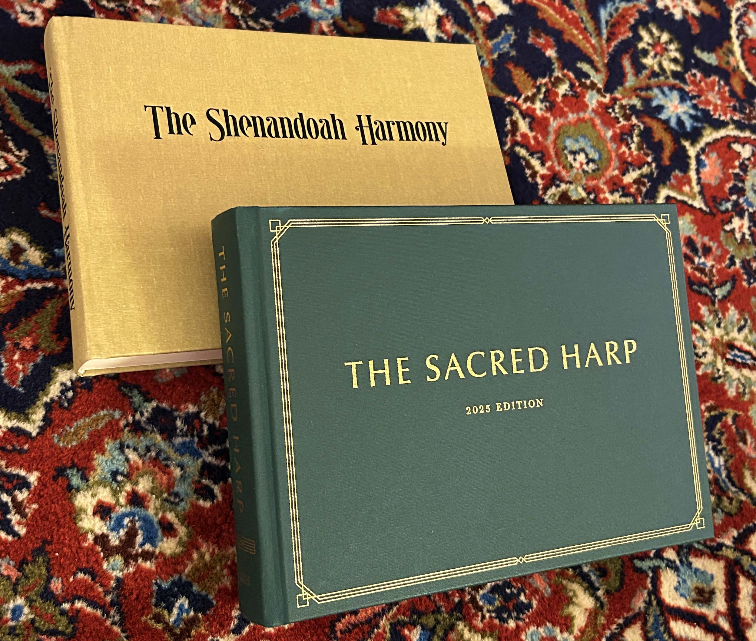 [photo of Sacred Harp 2025 Revision and Shenandoah Harmony tunebooks]
